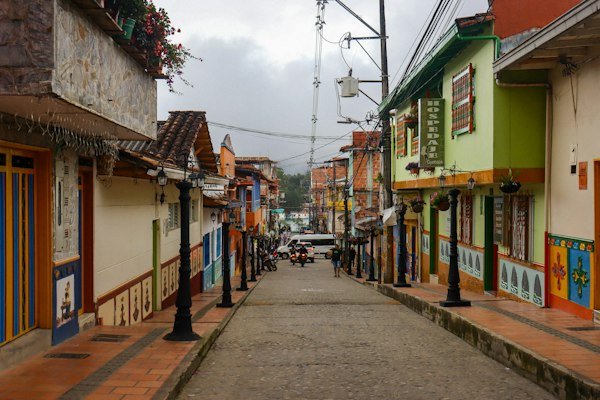 Colourful buildings lining a steep cobblestone street, illustrating an Antioquia town escape